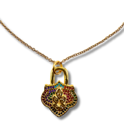 Gold padlock-shaped pendant with colorful stones on a white background