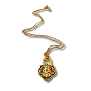 Gold necklace with a colorful pendant on a white background