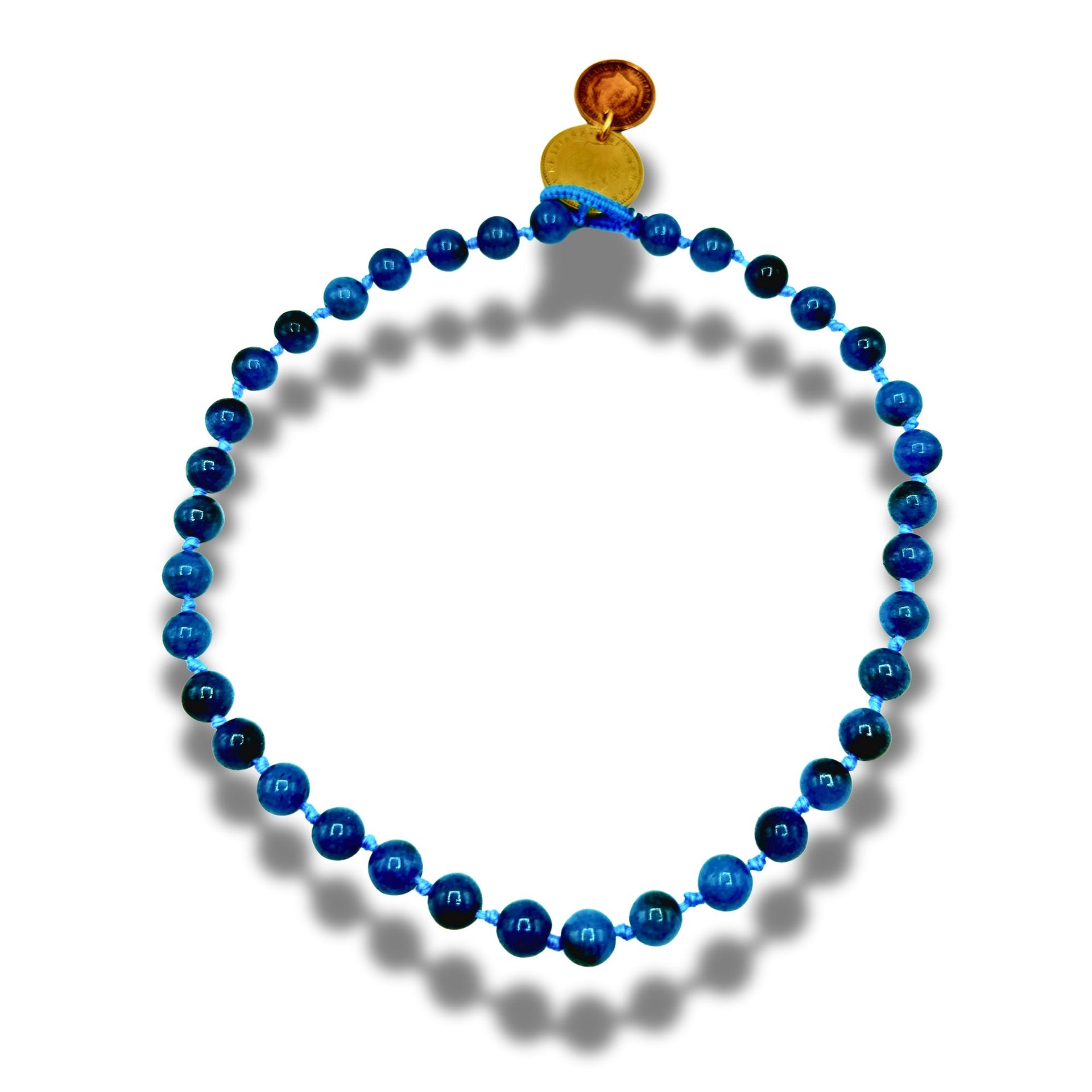 Blue beaded necklace with a coin pendant on a white background