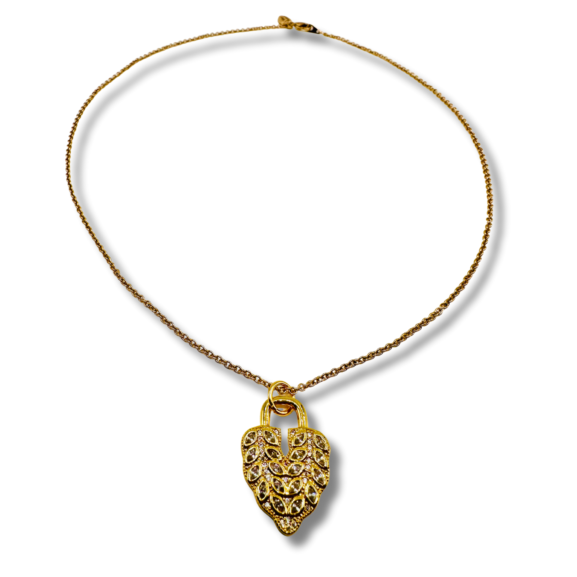 Gold necklace with a heart-shaped pendant on a white background