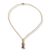 Gold necklace with a fish pendant on a white background