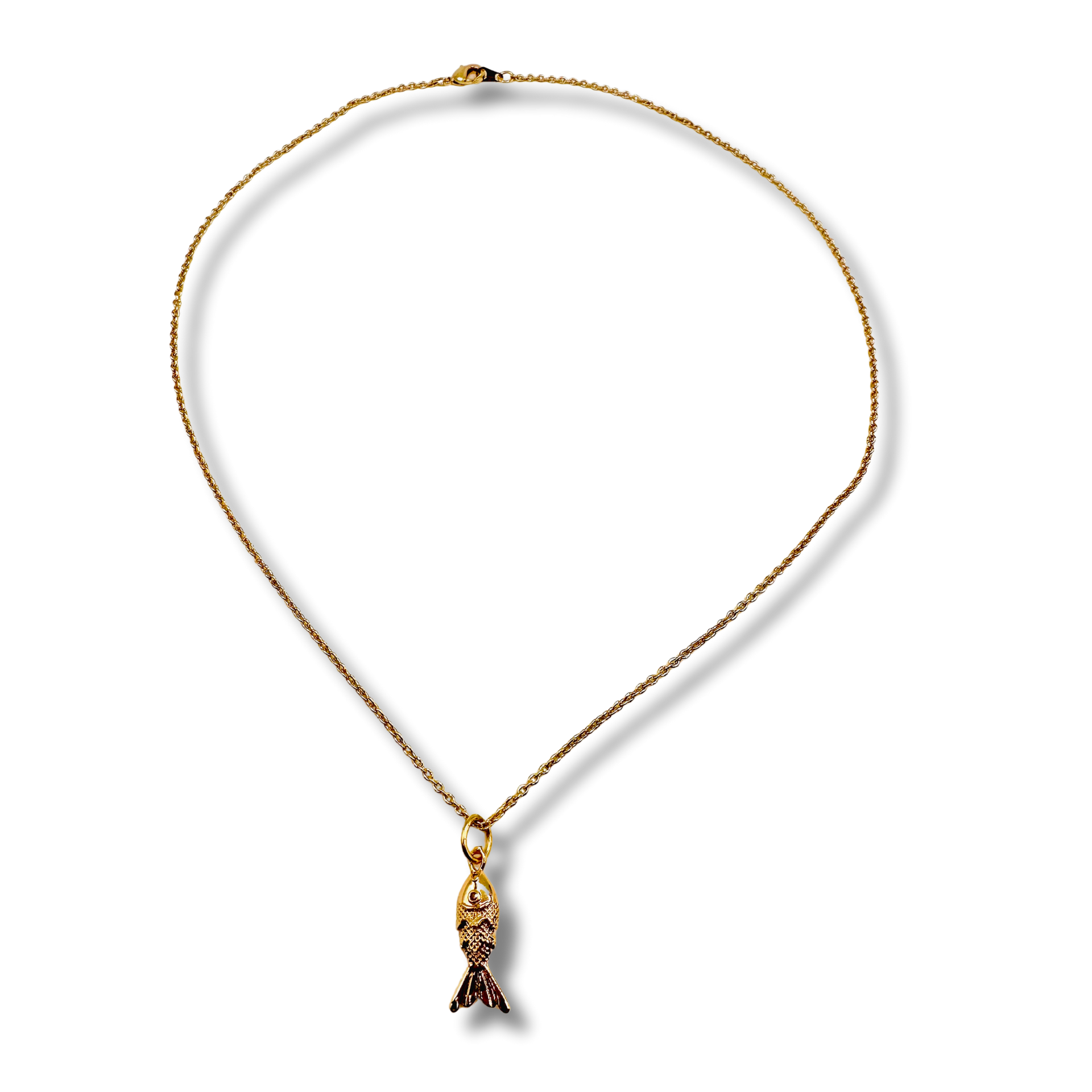 Gold necklace with a fish pendant on a white background