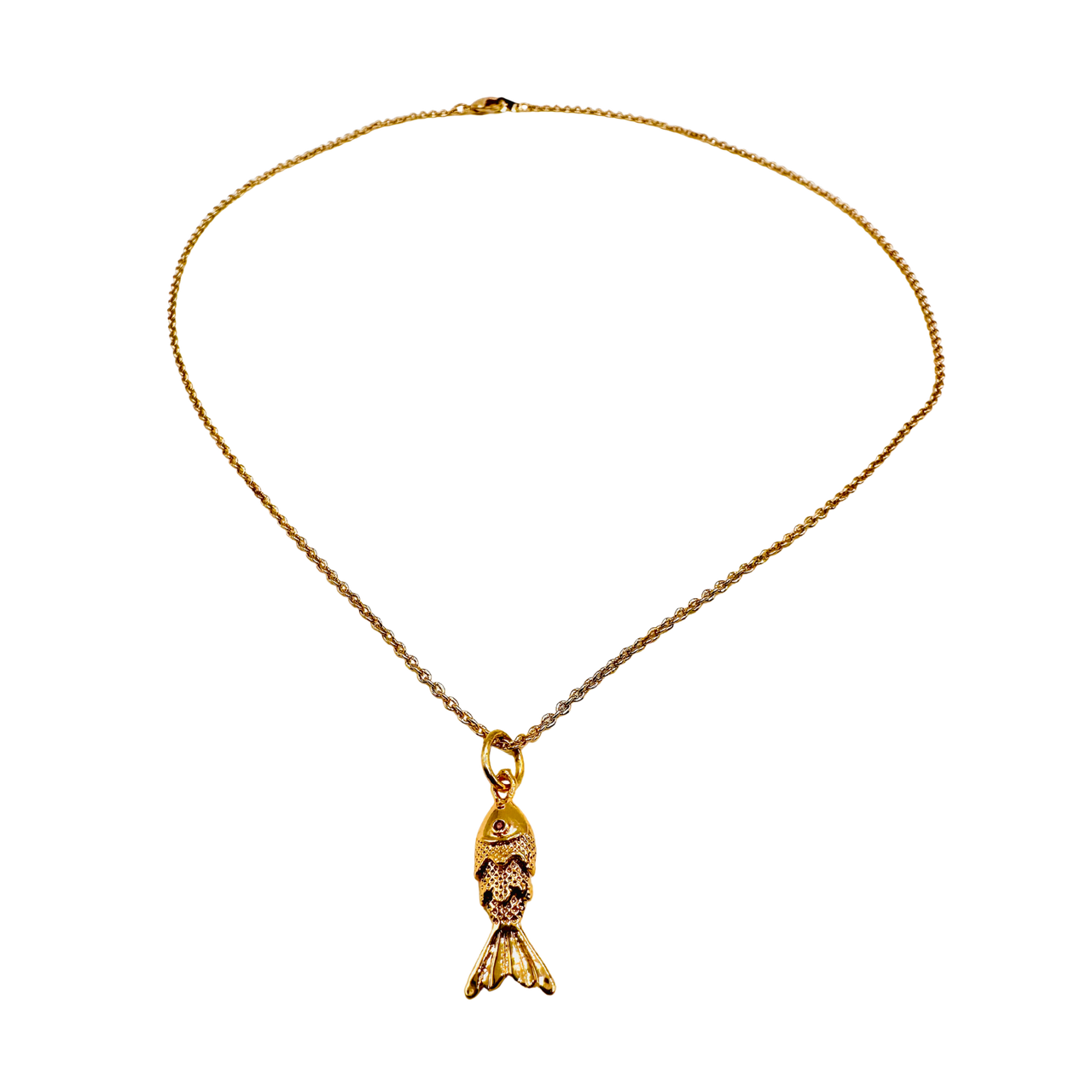 Gold necklace with a fish-shaped pendant on a white background