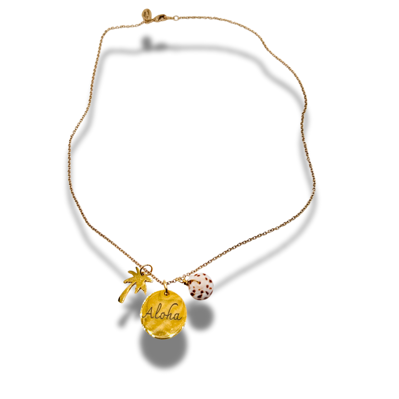 Gold necklace with 'Aloha' pendant on a white background