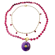 Necklace with pink beads and a purple pendant on a white background