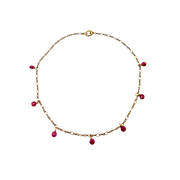 Gold necklace with red beads on a white background