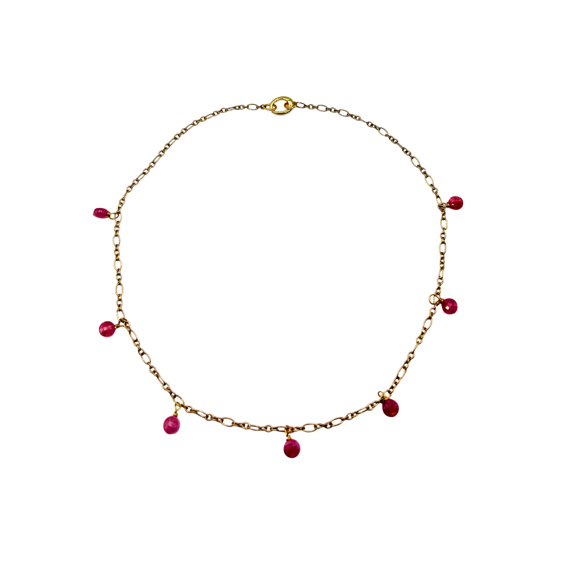 Gold necklace with red beads on a white background
