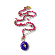 Necklace with pink beads and a purple pendant on a white background