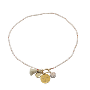 Necklace with tassel and charms on a white background