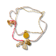 Necklace with pink and gold elements on a white background