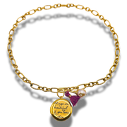 Gold bracelet with a charm and tassel on a white background