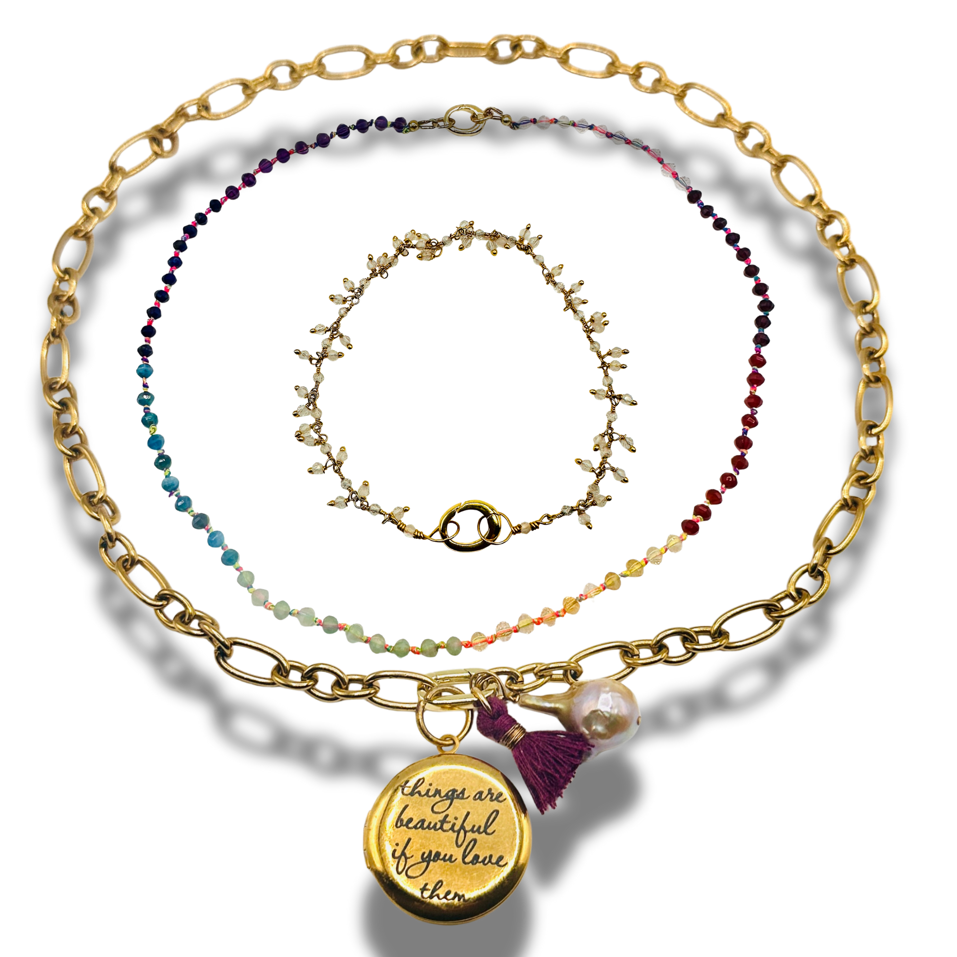 Set of gold and beaded necklaces on a white background