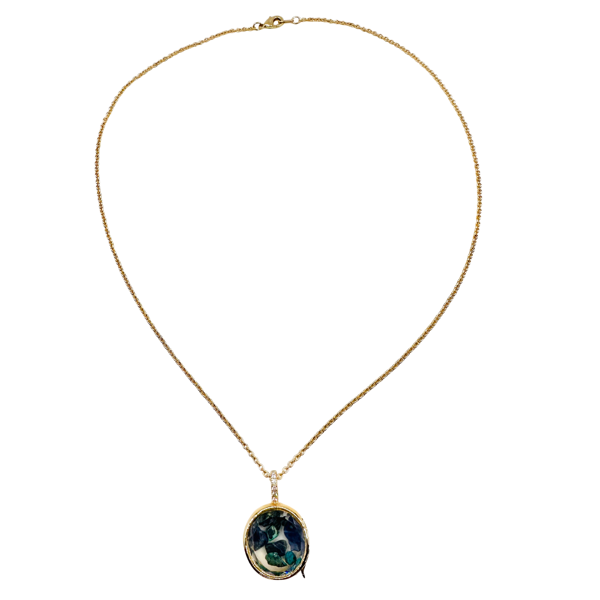 A gold chain necklace with an oval pendant featuring a dark green and blue marbled pattern surrounded by a gold border, shown against a plain white background.