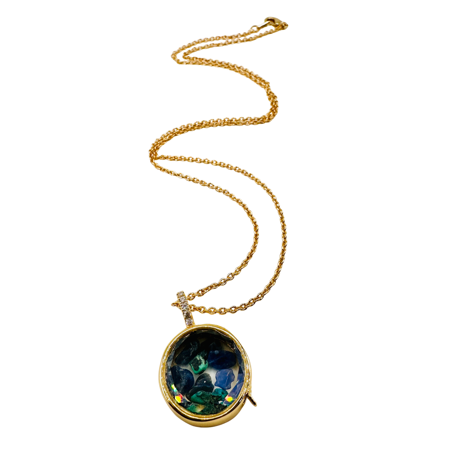 A gold chain necklace with an oval pendant featuring a colorful, marbled pattern resembling green, blue, and gold, set against a plain white background.