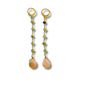 Pair of gold earrings with green beads and peach-colored teardrop stones on a white background