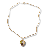 Gold necklace with a heart-shaped pendant on a white background