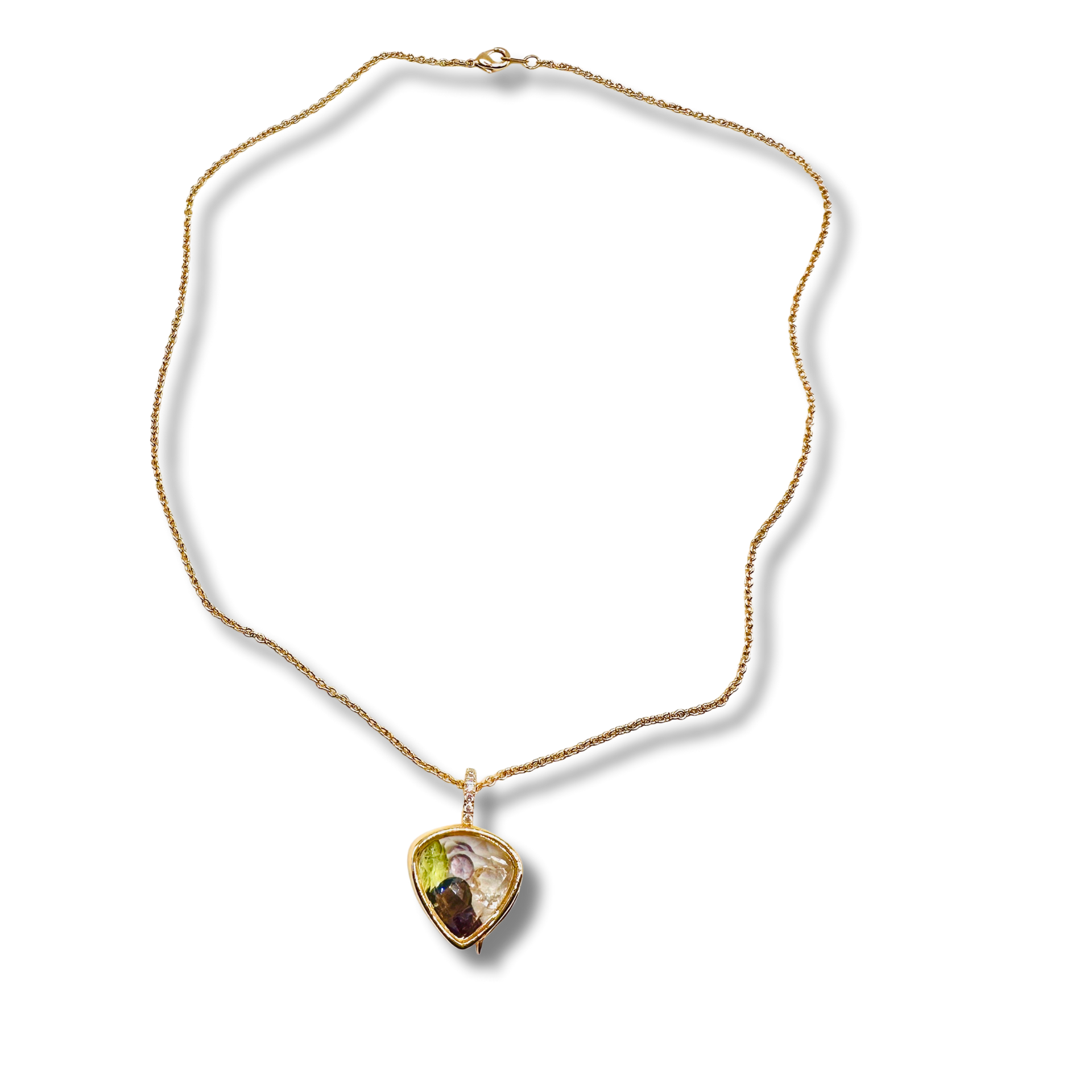 Gold necklace with a heart-shaped pendant on a white background