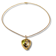 Gold necklace with a heart-shaped gemstone pendant on a white background