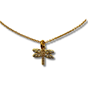 Gold dragonfly pendant necklace on a white background