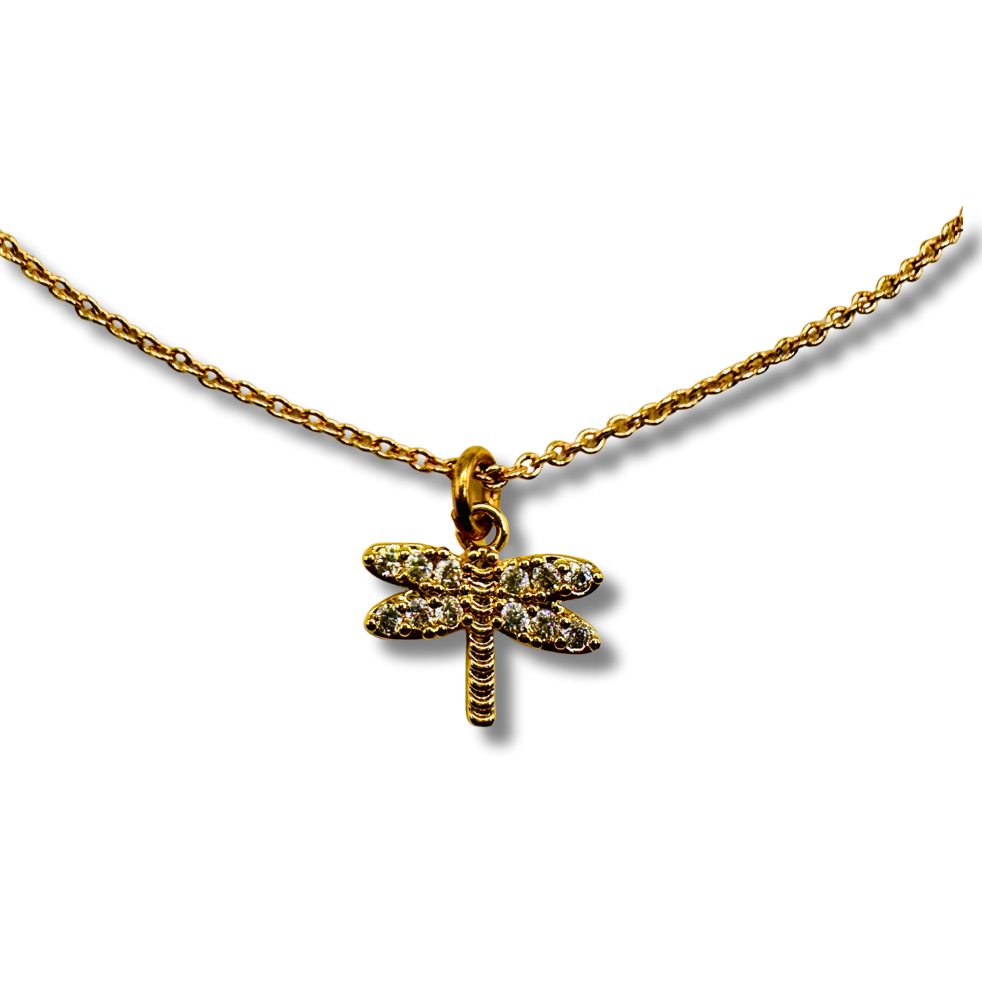 Gold dragonfly pendant necklace on a white background