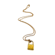 Gold padlock necklace on a white background