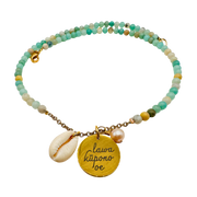 Beaded bracelet with gold charm and shell pendant on a white background