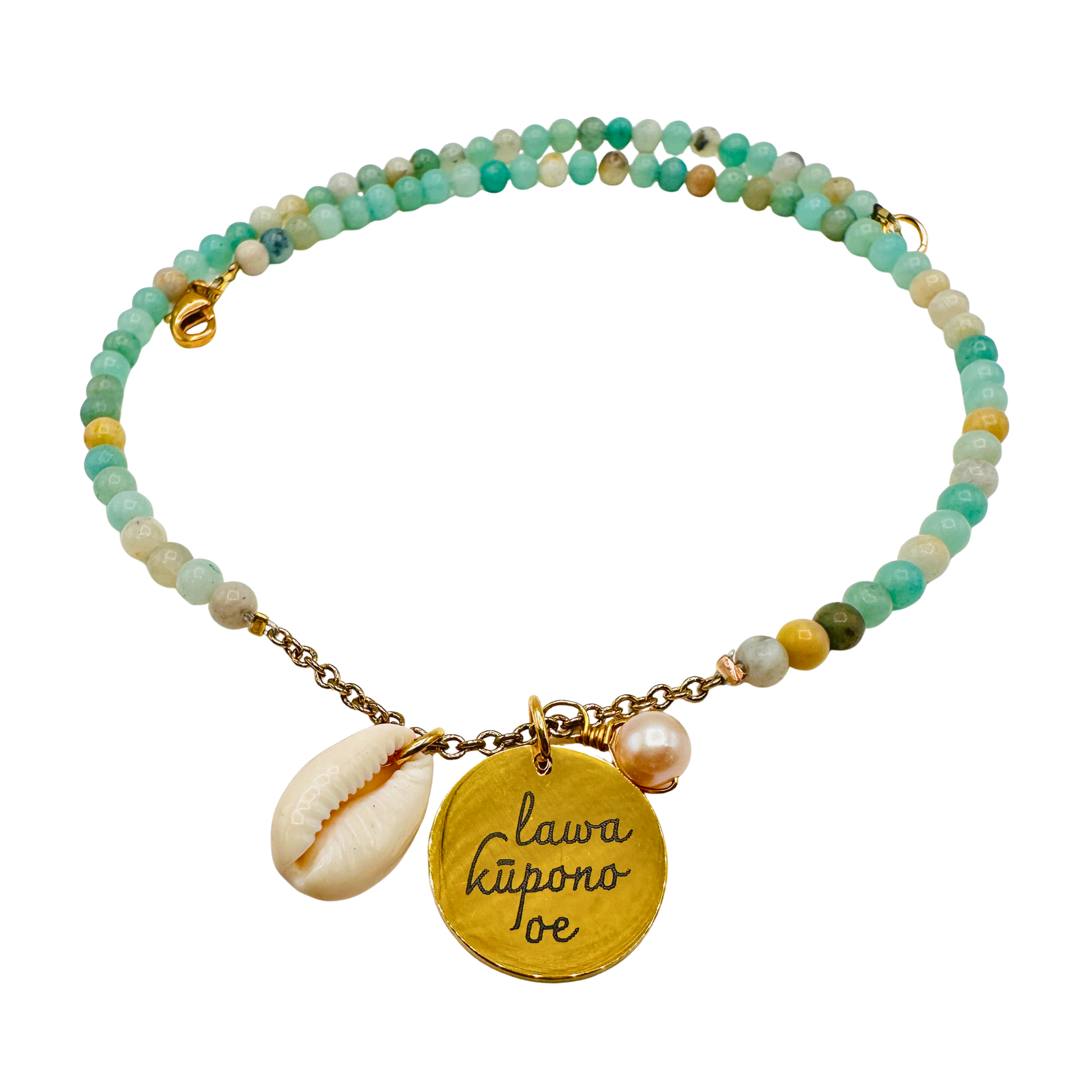 Beaded bracelet with gold charm and shell pendant on a white background