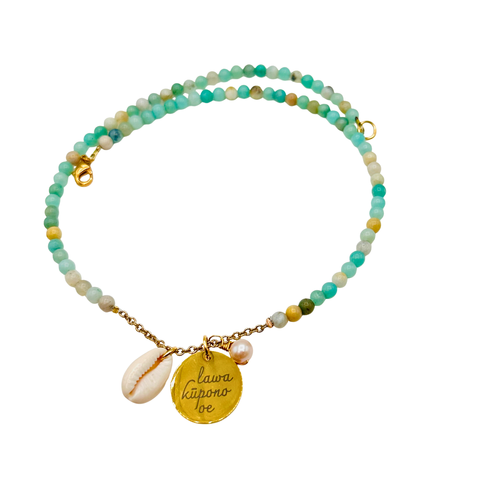 Multicolored beaded bracelet with gold charm and shell on a white background
