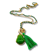 Necklace with green Buddha pendant and tassel on a white background