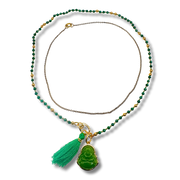Necklace with green beads and tassel pendant on a white background