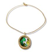 Gold necklace with a green pendant on a white background