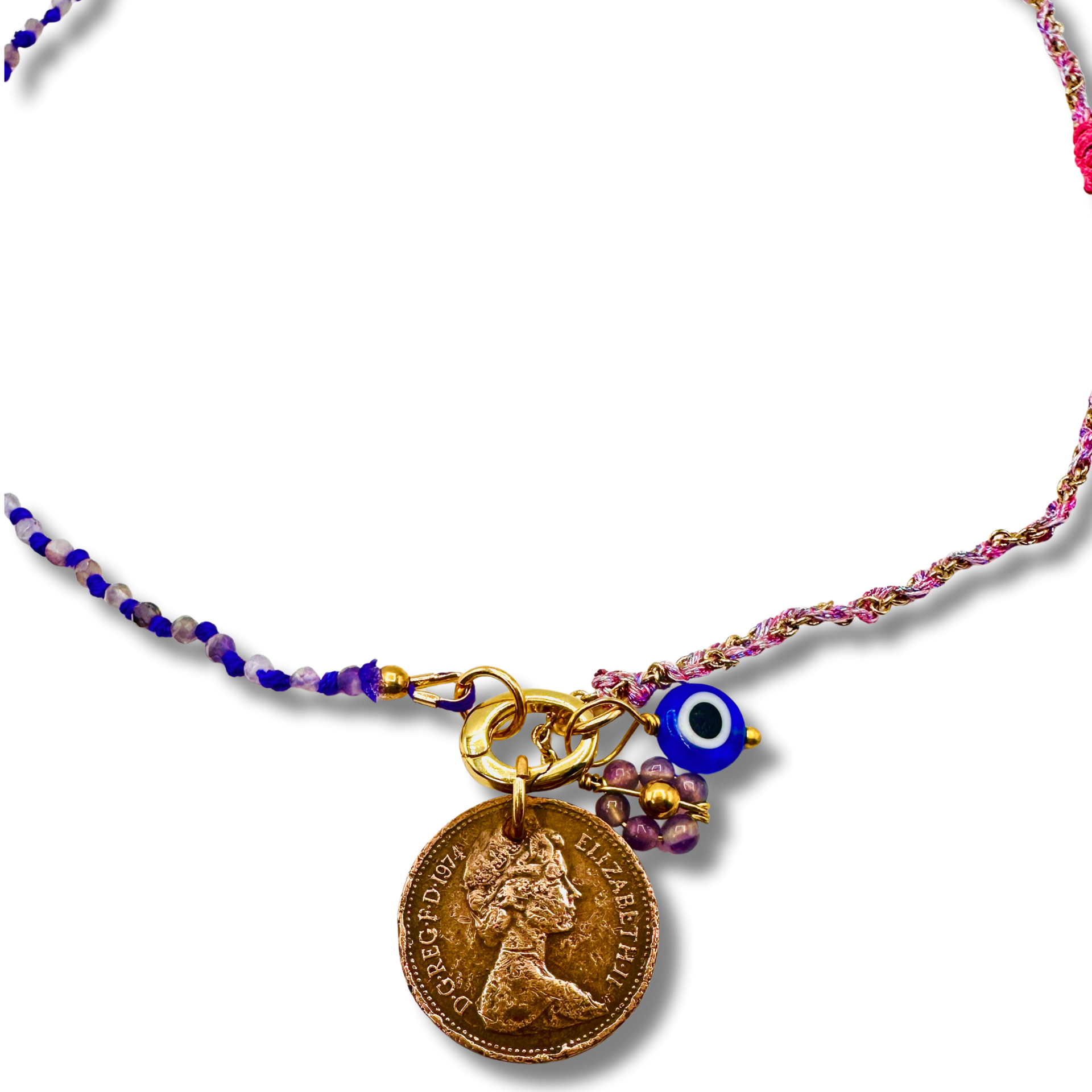 Necklace with various charms including a coin, blue evil eye, and floral elements on a white background