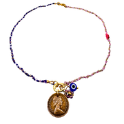 Necklace with a gold coin charm and blue evil eye charm on a beaded chain against a white background