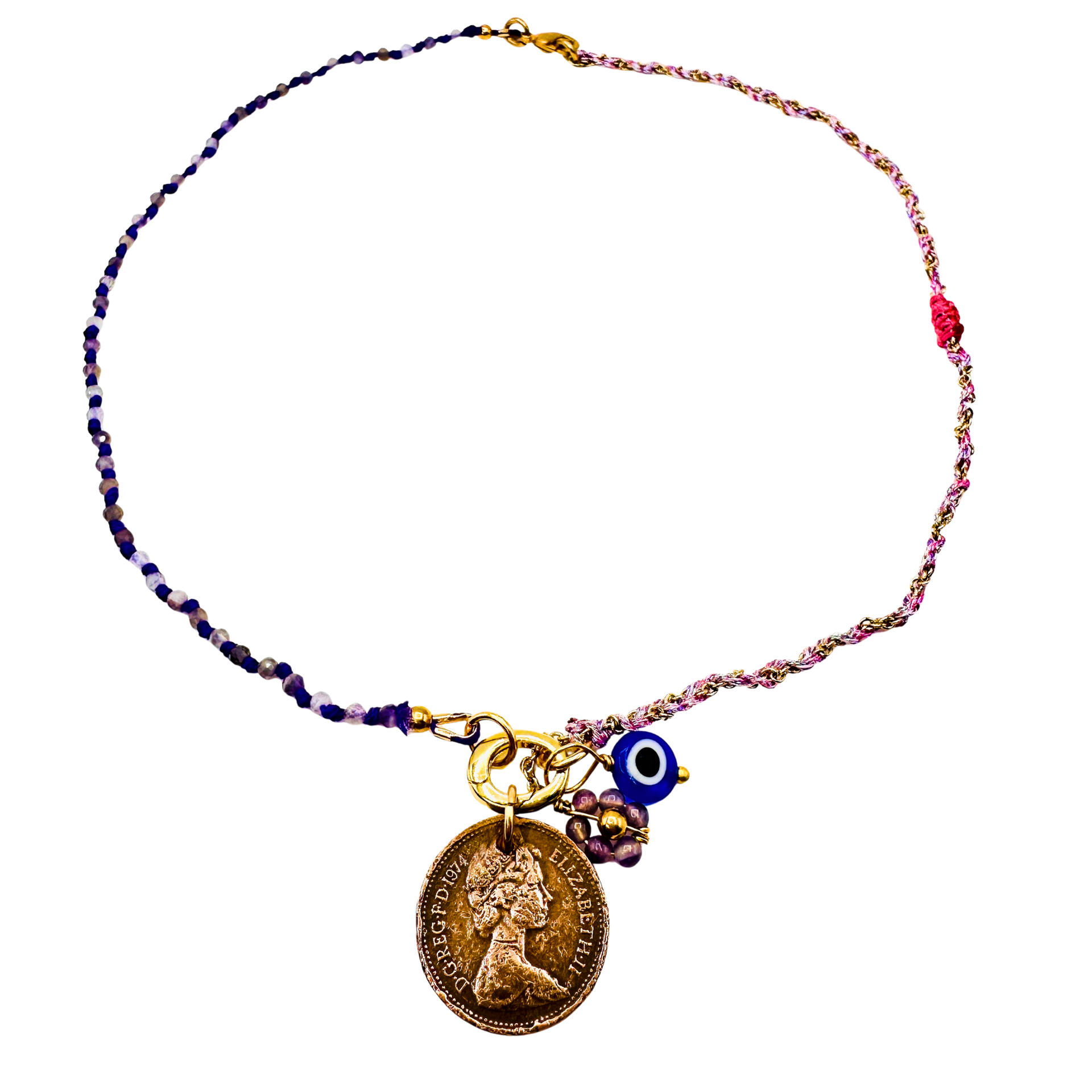 Necklace with a gold coin charm and blue evil eye charm on a beaded chain against a white background