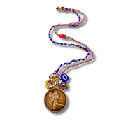 Colorful beaded necklace with a coin charm and evil eye pendant on a white background