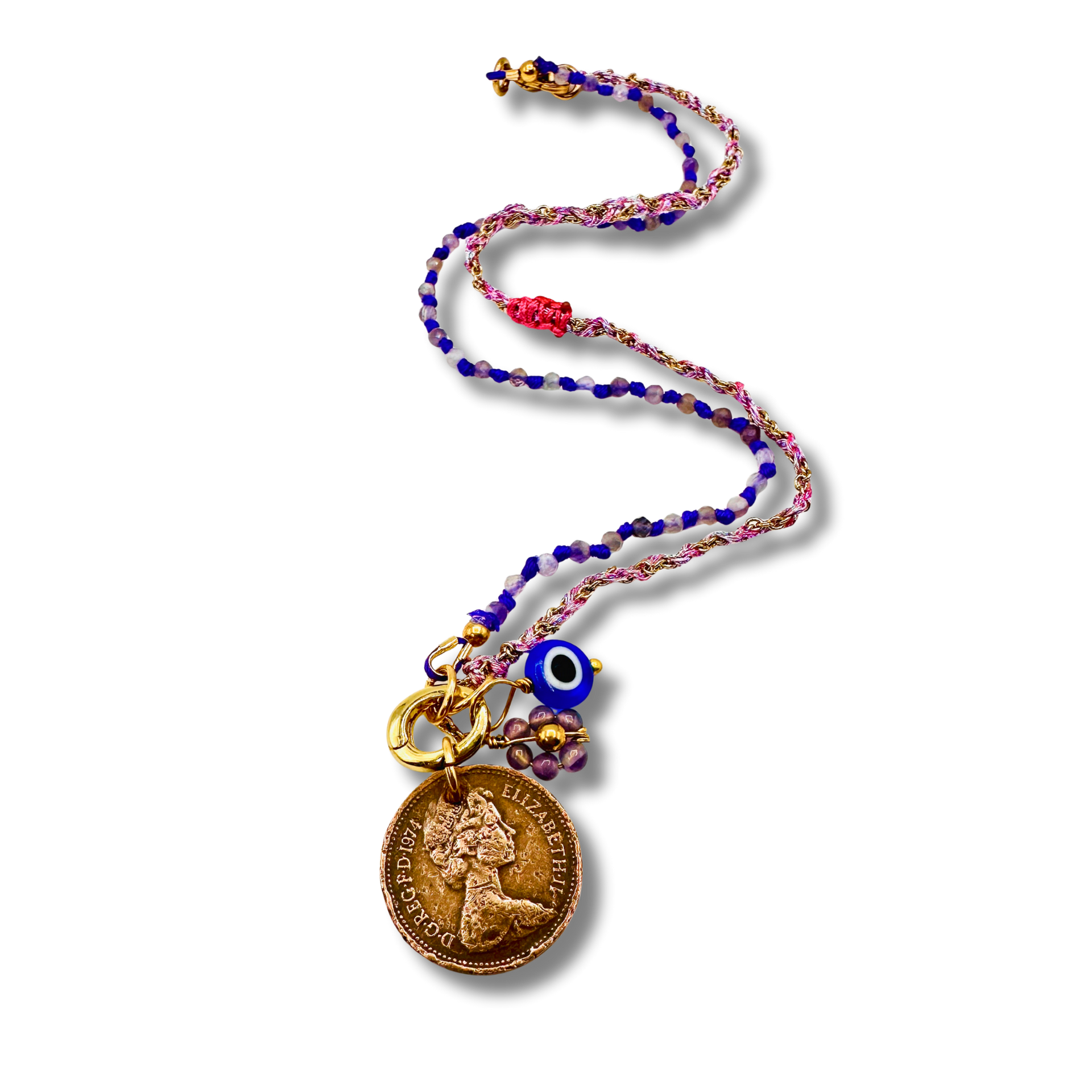 Colorful beaded necklace with a coin charm and evil eye pendant on a white background