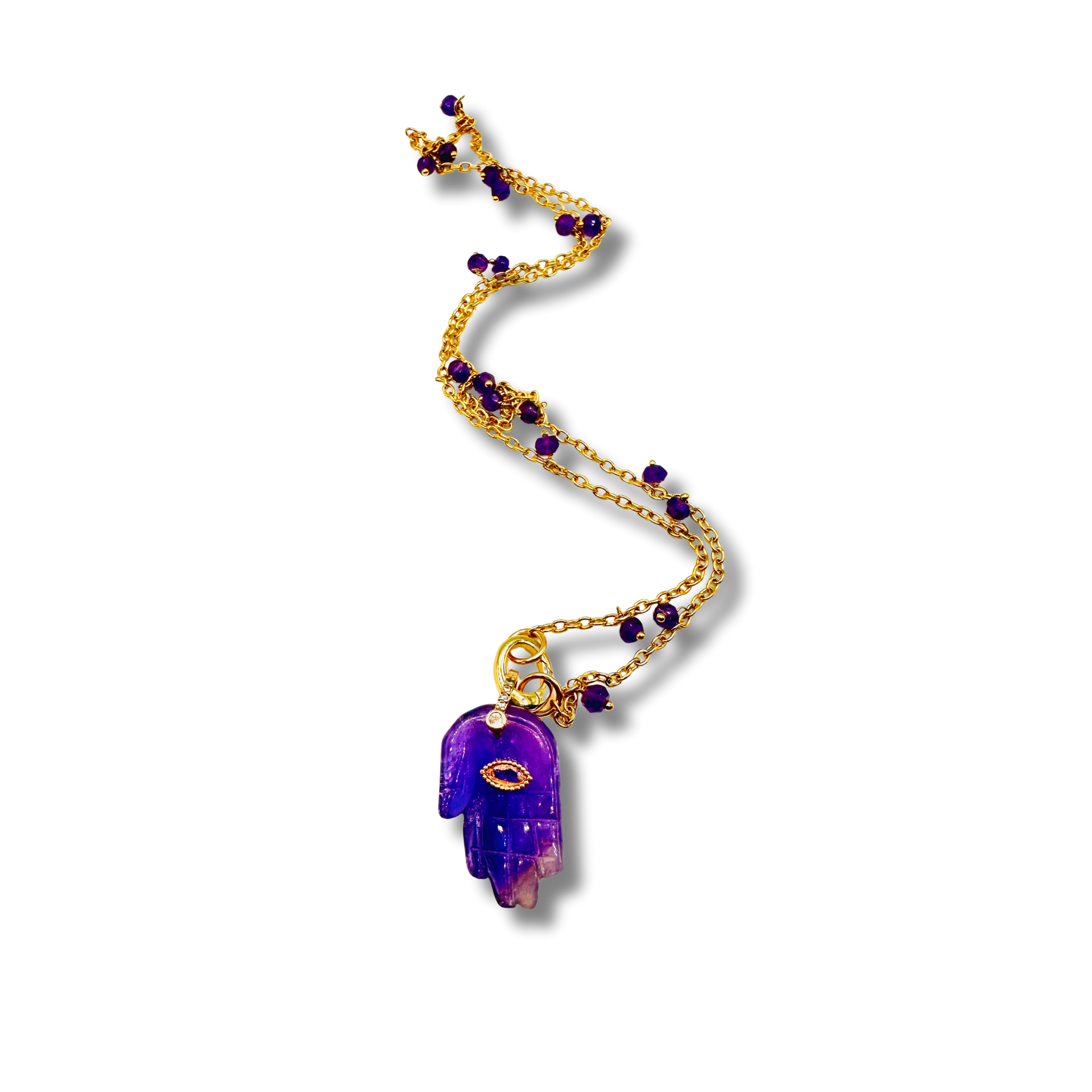 Gold necklace with purple amethyst pendant on a white background
