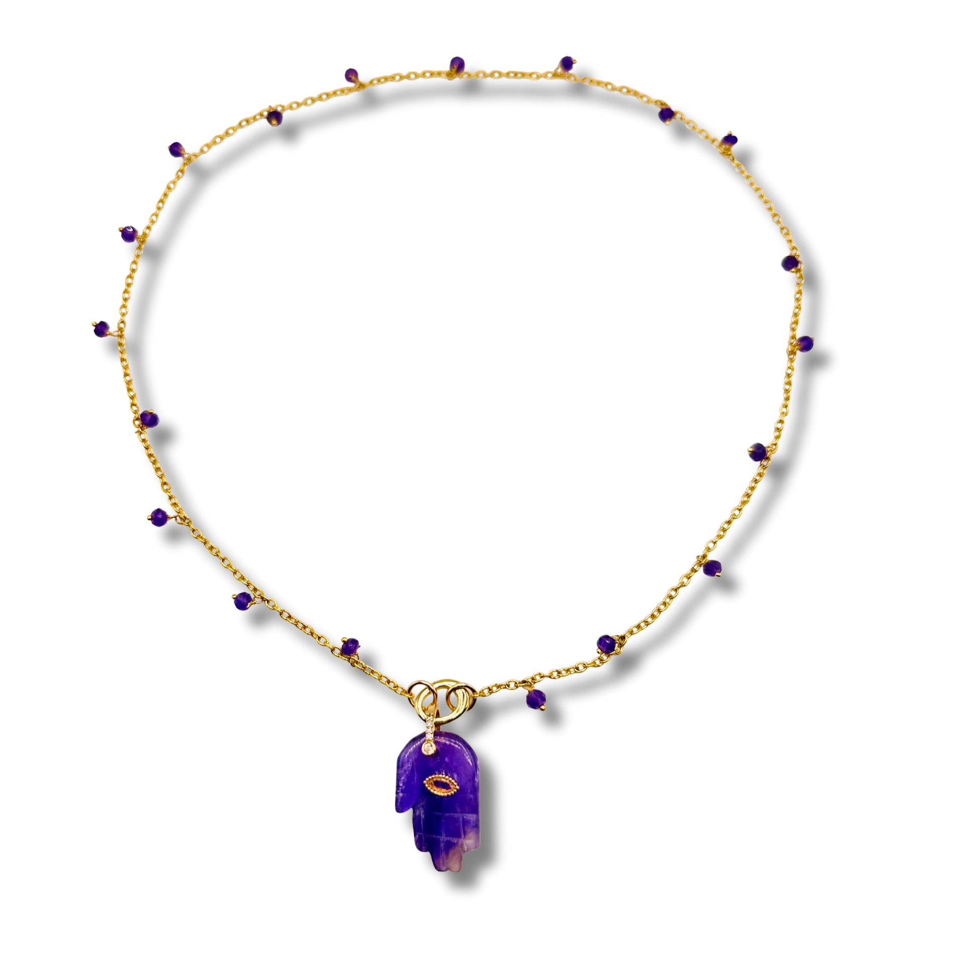 Necklace with purple pendant and gold chain on a white background