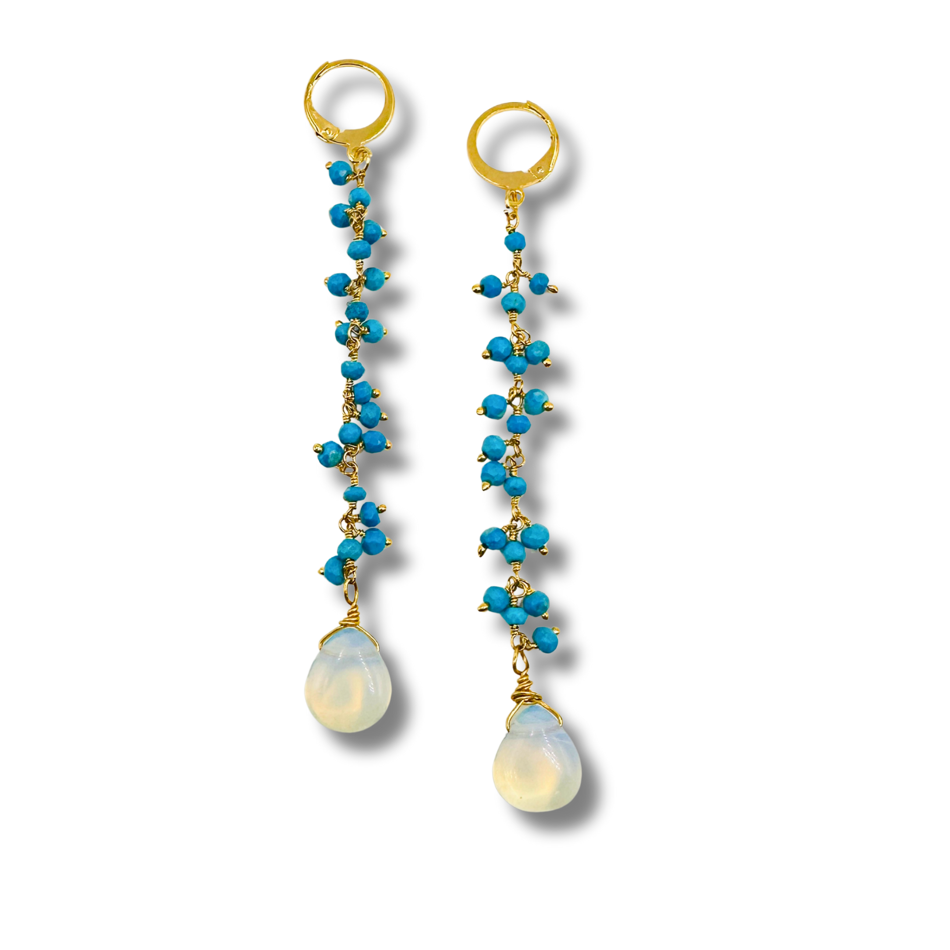 Pair of earrings with blue beads and white stones on a white background