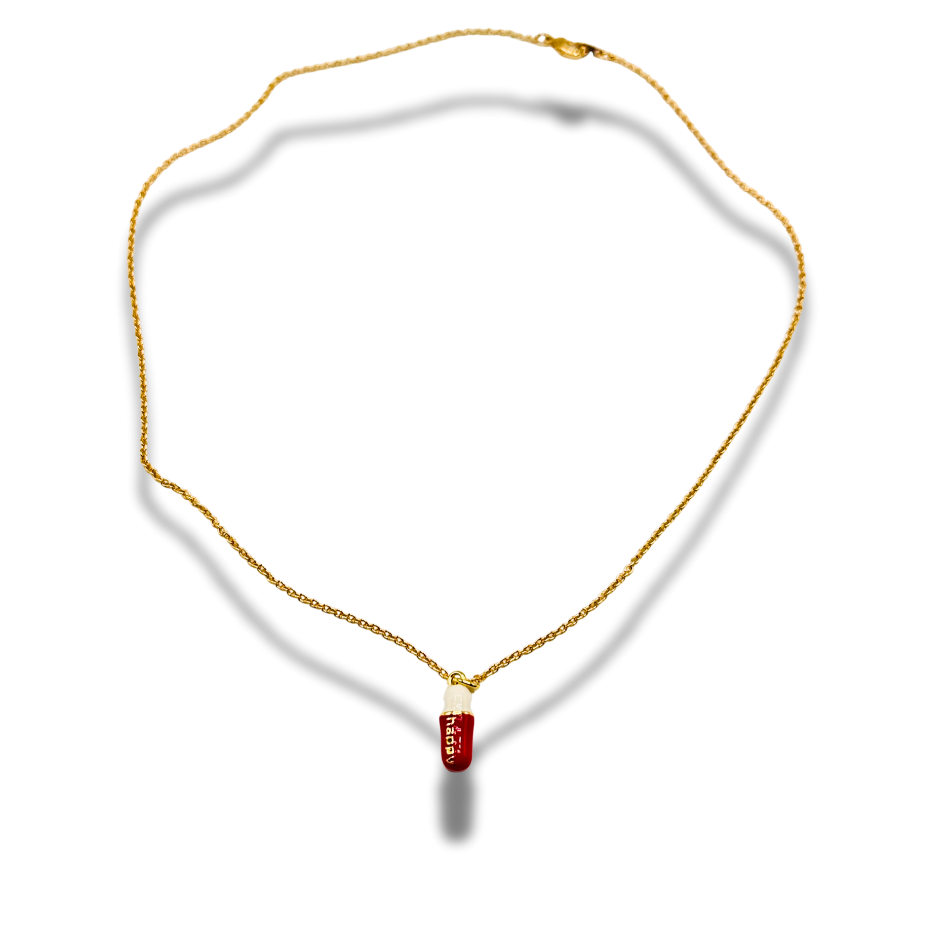 Gold necklace with a red pendant on a white background