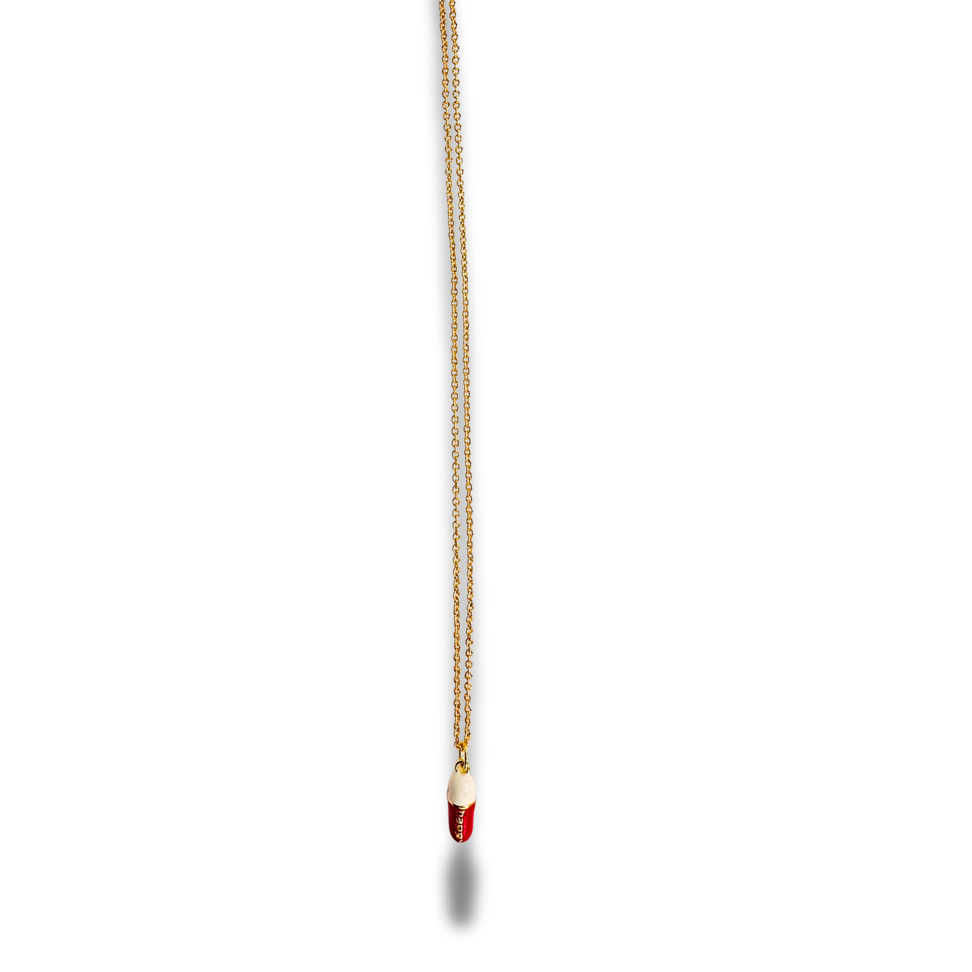Gold necklace with a red pendant on a white background