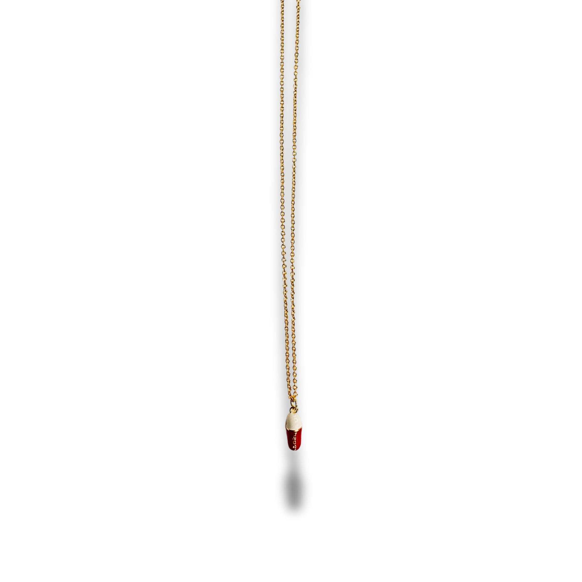 Gold necklace with a red pendant on a white background