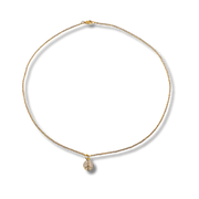 Gold necklace with a teardrop-shaped pendant on a white background