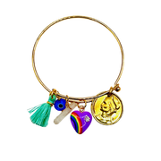 Gold bracelet with various charms including a rainbow heart, tassel, and coin on a white background
