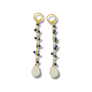 Pair of earrings with gold loops, blue and white beads, and teardrop-shaped stones on a white background.
