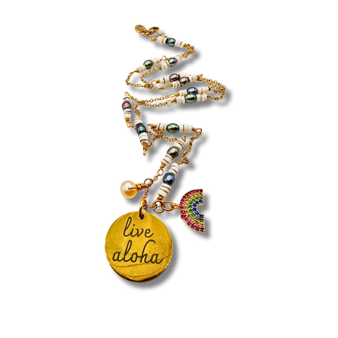 Necklace with 'live aloha' pendant and rainbow charm on a white background