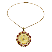 Gold necklace with a circular pendant featuring red stones on a white background