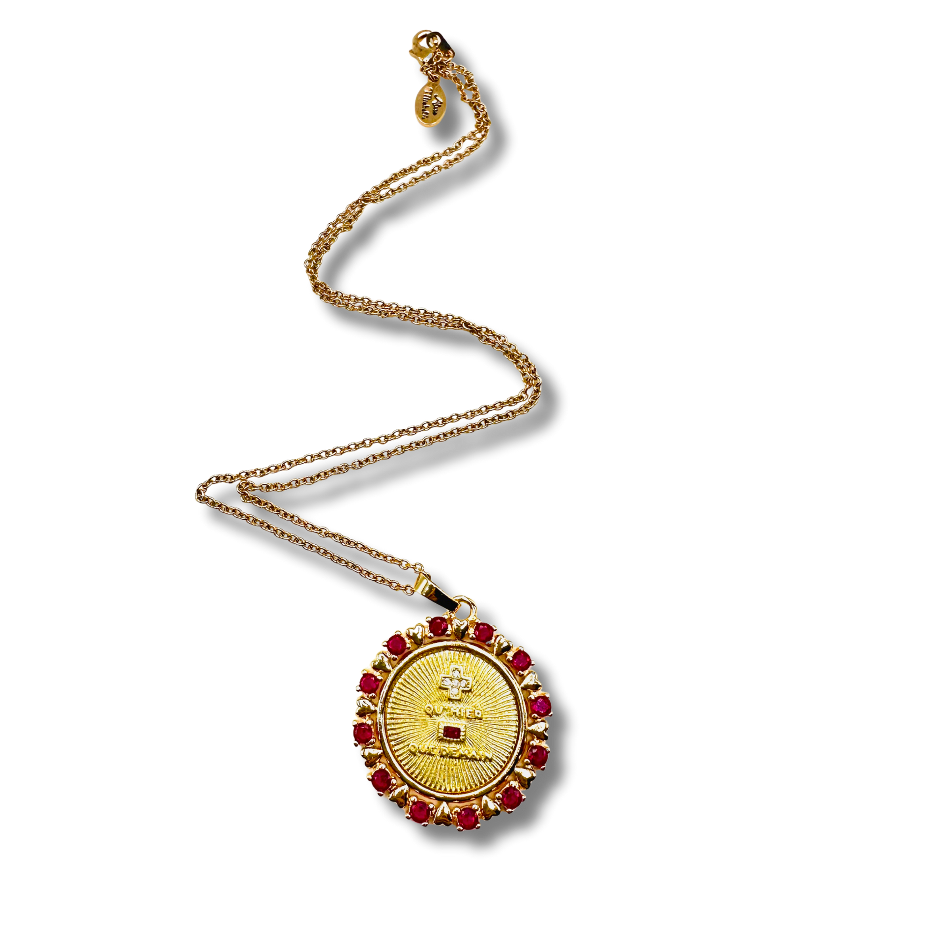 Gold necklace with a round pendant featuring red stones on a white background
