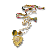 Colorful beaded necklace with heart pendant on a white background