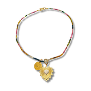 Necklace with colorful beads and gold heart pendant on a white background